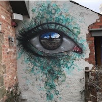 an eye painted on the side of a building