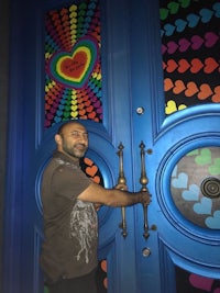 a man standing in front of a colorful door